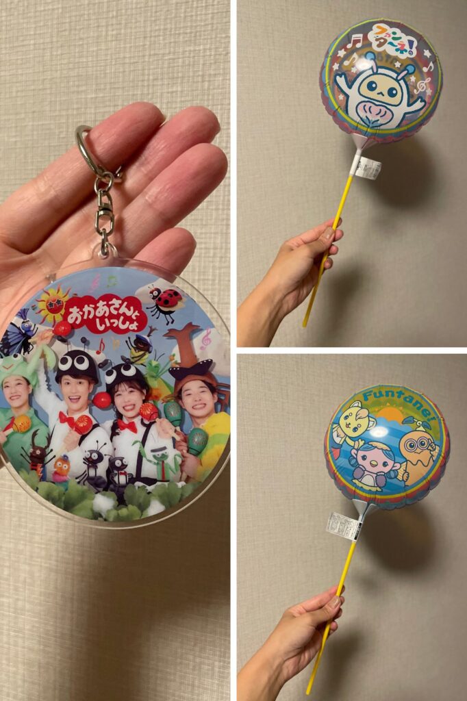 A keychain featuring colorful characters from a children's show, held in a hand.